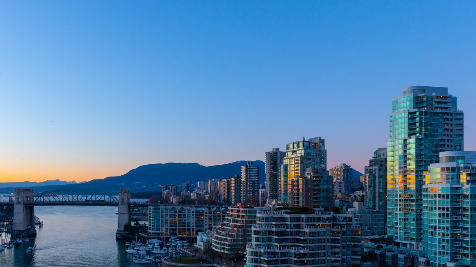 Vancouver skyline at sunset for families comparing babysitting and Nanny care.
