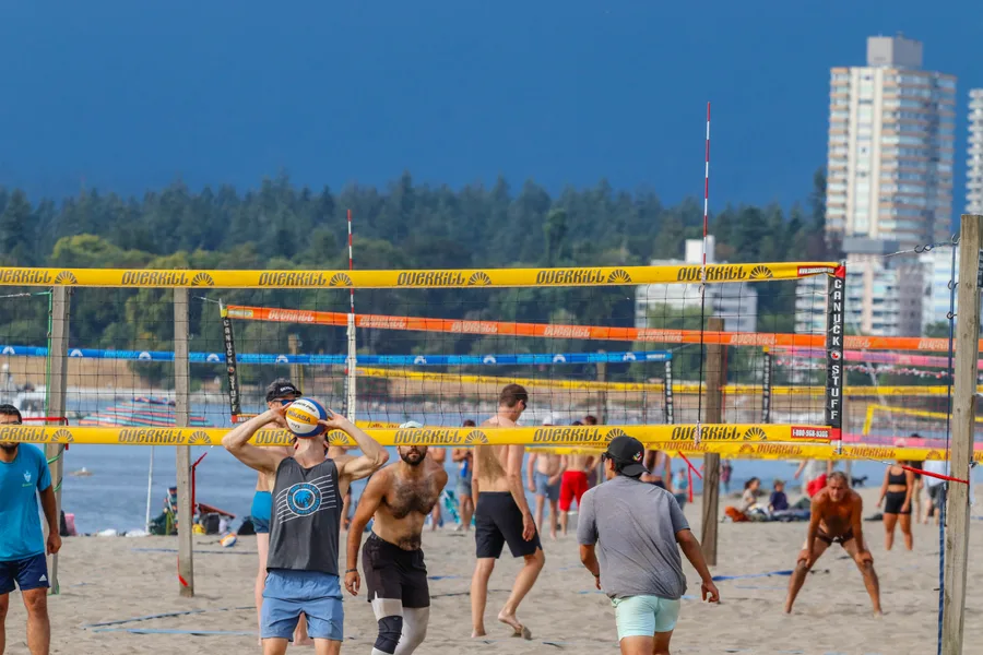 Beach volleyball players on a sunny day in Kitsilano