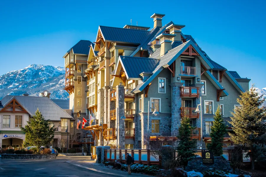 Snow-covered chalet and ski runs in Whistler village